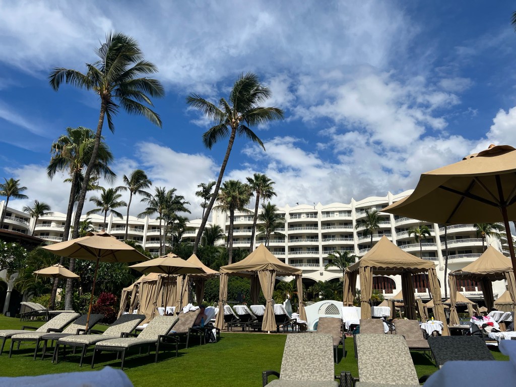 View of the hotel and pool area behind us while sitting on the hillside. 