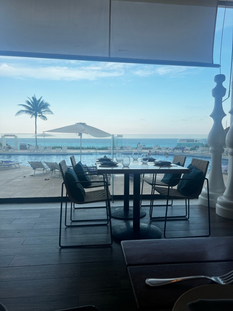 A picture from our dinner table looking out over one of the pools and into the ocean. 