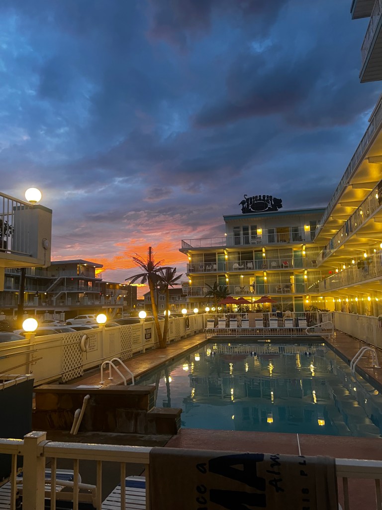 Pic of pool and hotel at night.